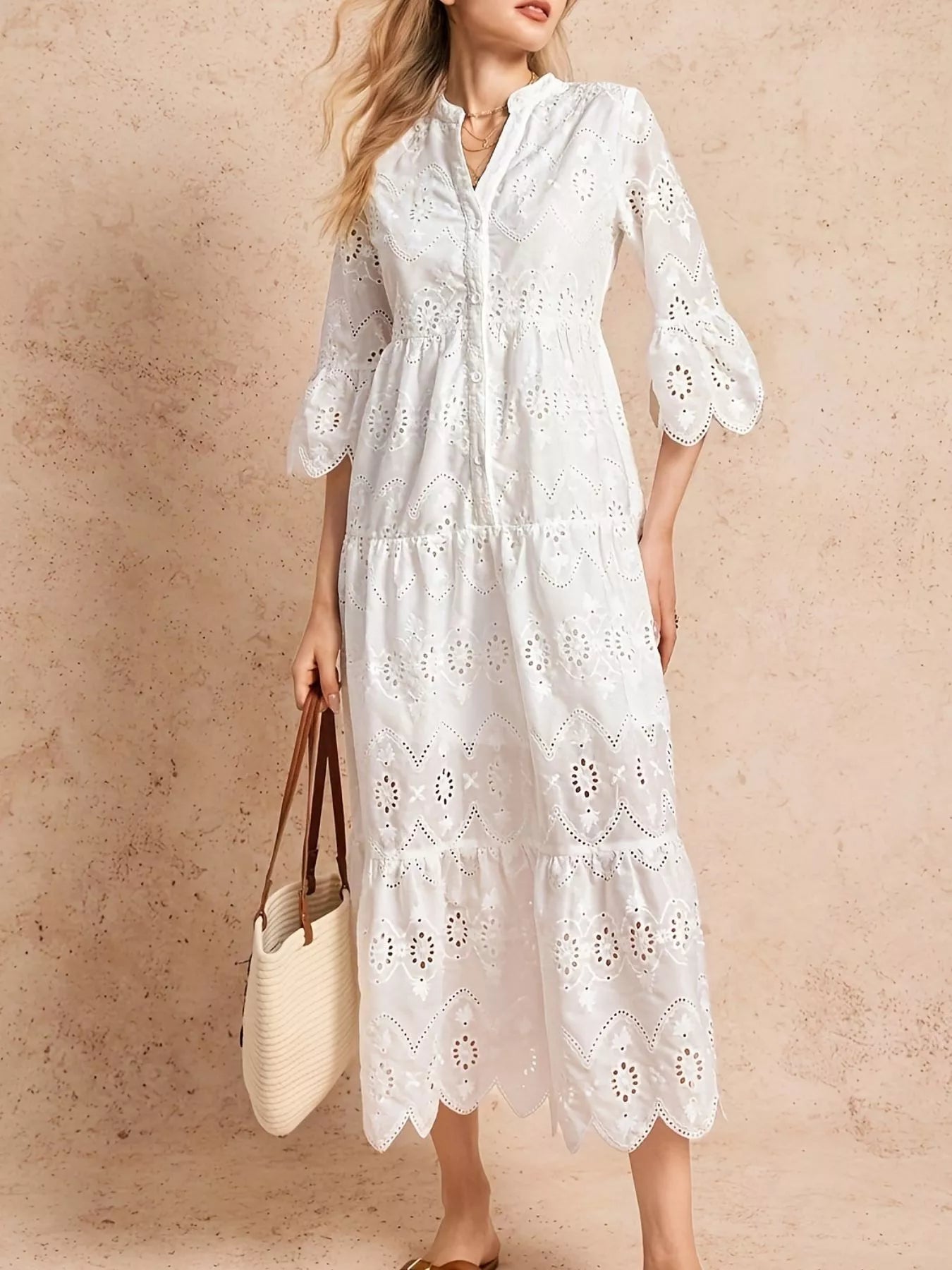 NEWYORKLISTED STYLE COLLLECTION: Woman wearing a white lace dress against a beige background