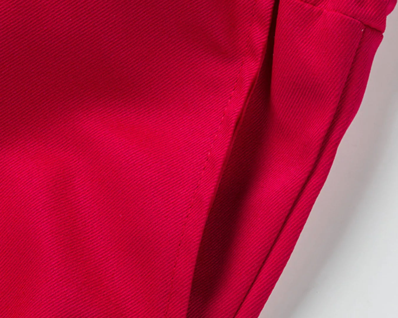 NEWYORKLISTED ATLAS MEN'S COLLECTION: Close-up of a red fabric with an elastic waistband on a light gray background