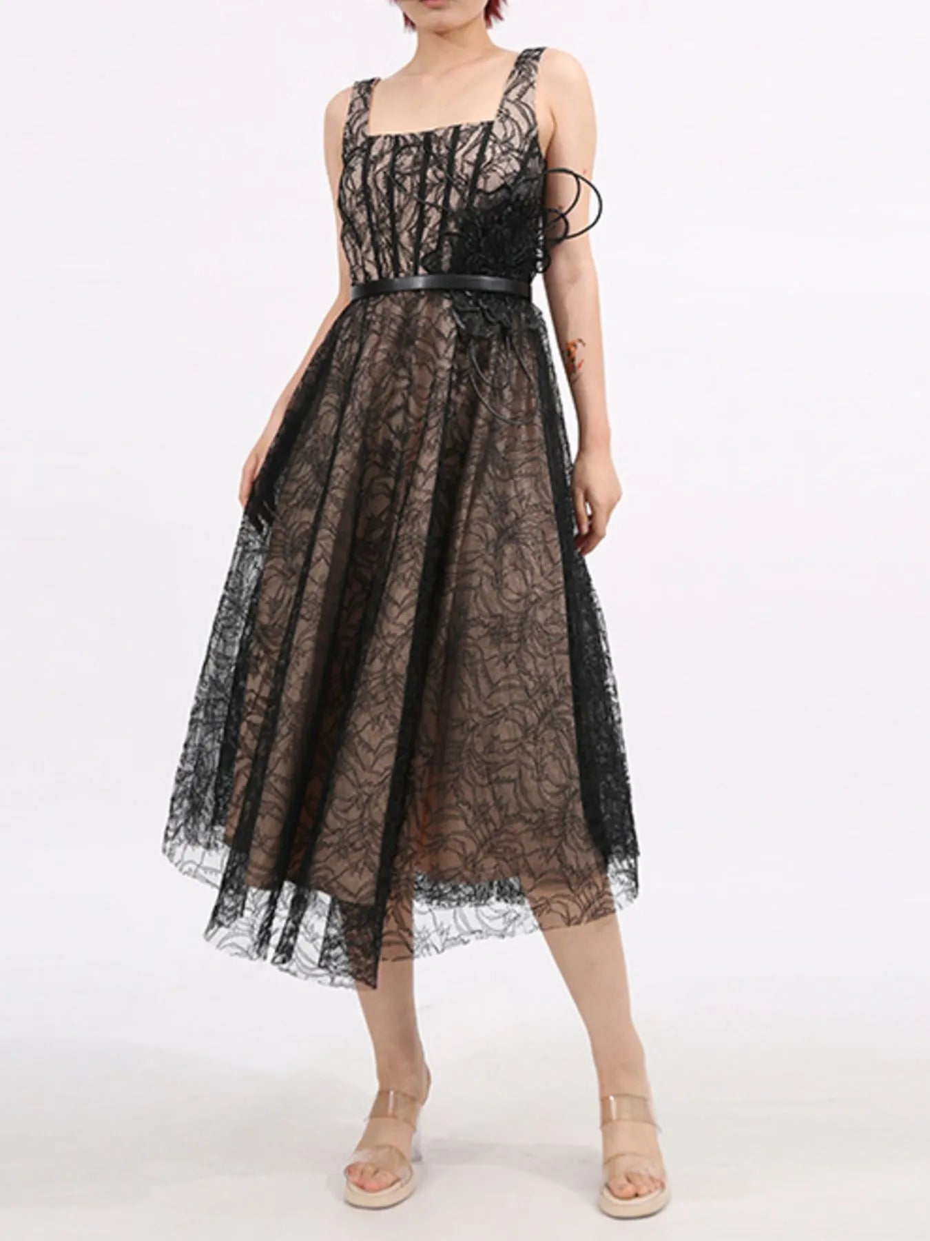 NEWYORKLISTED RUNWAY STYLE: Black lace dress worn by a person on a white background