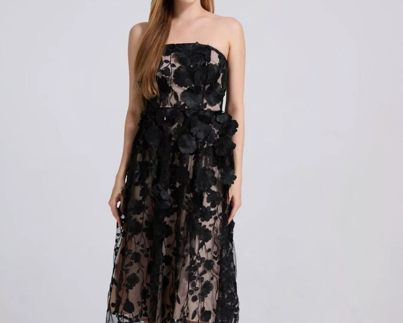 NEWYORKLISTED STYLE COLLECTION: Woman wearing a black floral dress on a white background