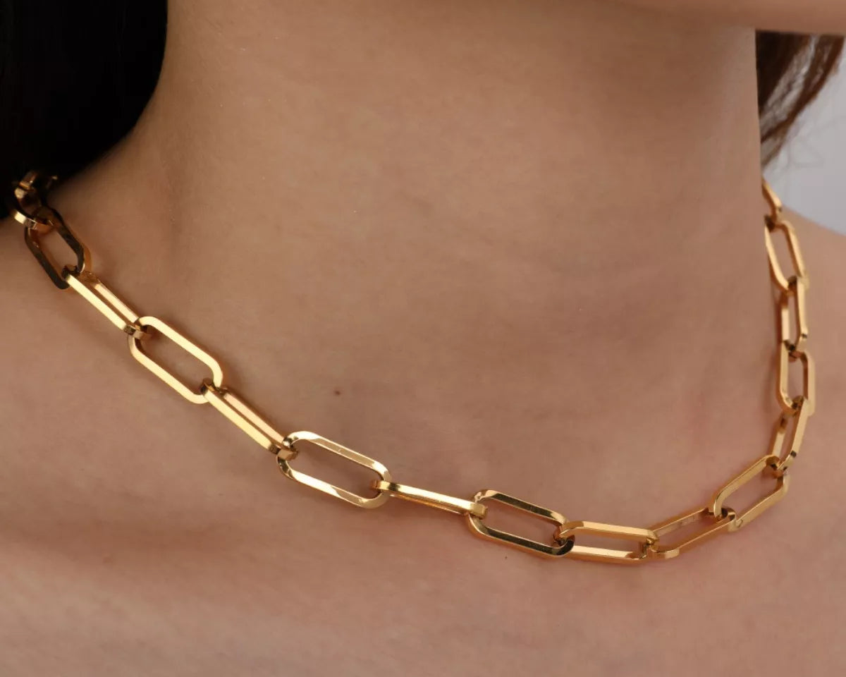NYLD Glamour Collection by NEWYORKLISTED: Gold chain necklace on a person's neck