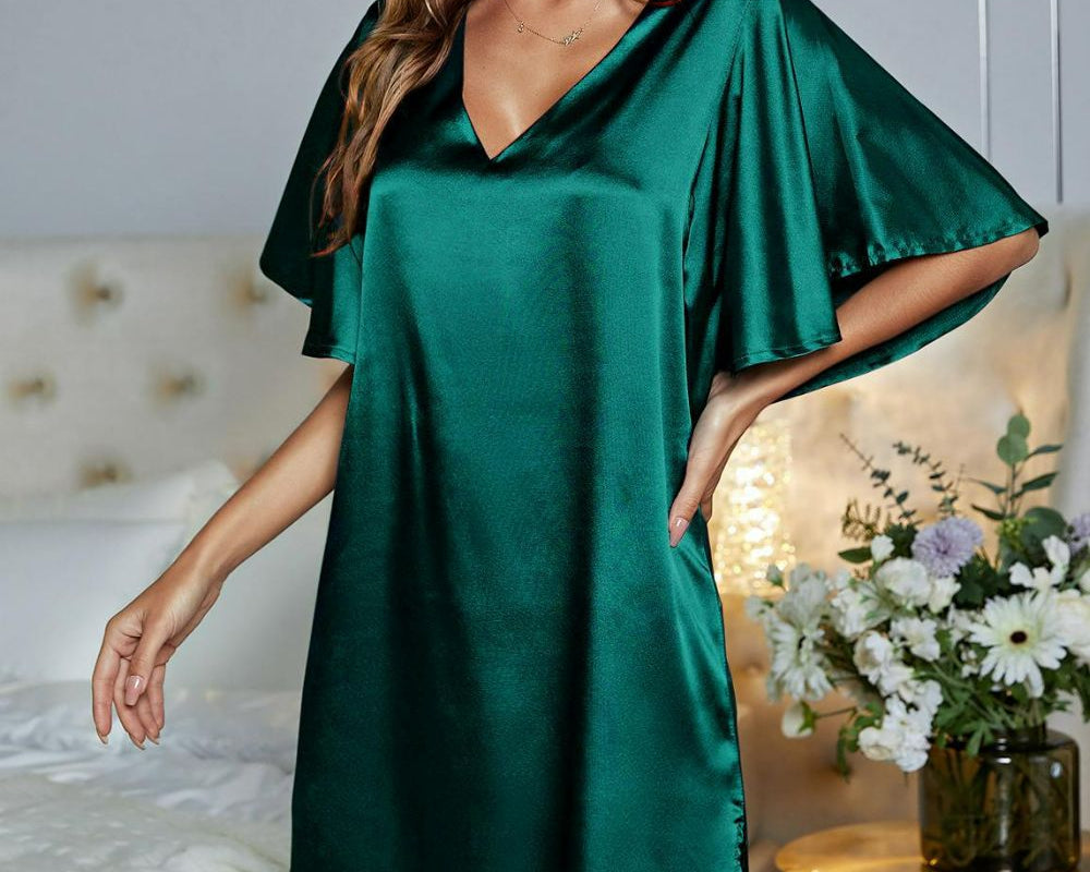 NEWYORKLISTED Intimate Apparel: Woman wearing a green satin nightgown in a bedroom setting.