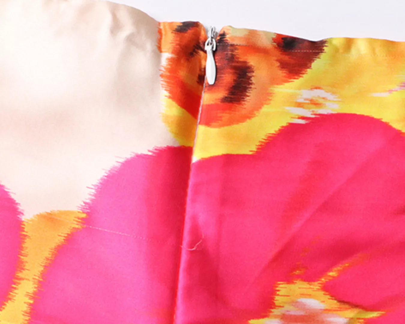 NEWYORKLSITED STYLE COLLECTION: Close-up of a colorful floral patterned fabric with pink, yellow, and orange colors.