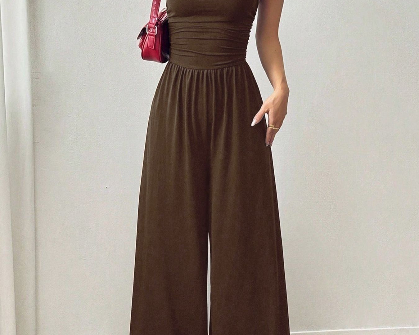 NEWYORKLISTED Comfort Collection: Woman wearing a brown jumpsuit with a plain background