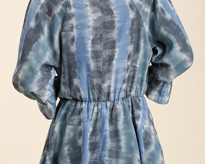 NEWYORKLISTED STYLE COLLECTION: Blue and gray tie-dye dress with puffed sleeves on a beige background