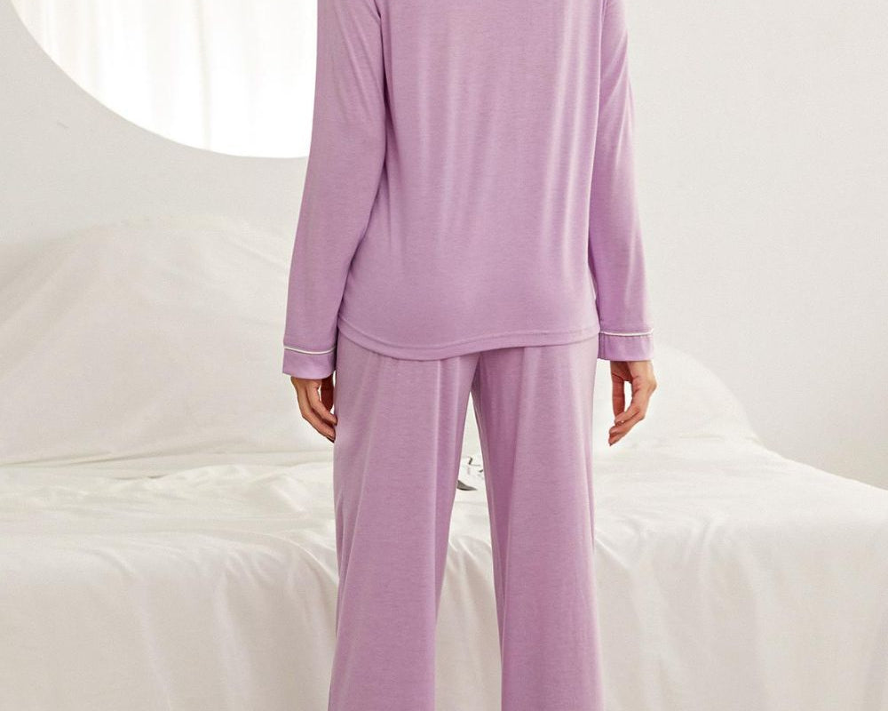 NEWYORKLISTED Intimate Apparel: Woman wearing a lavender pajama set against a white background