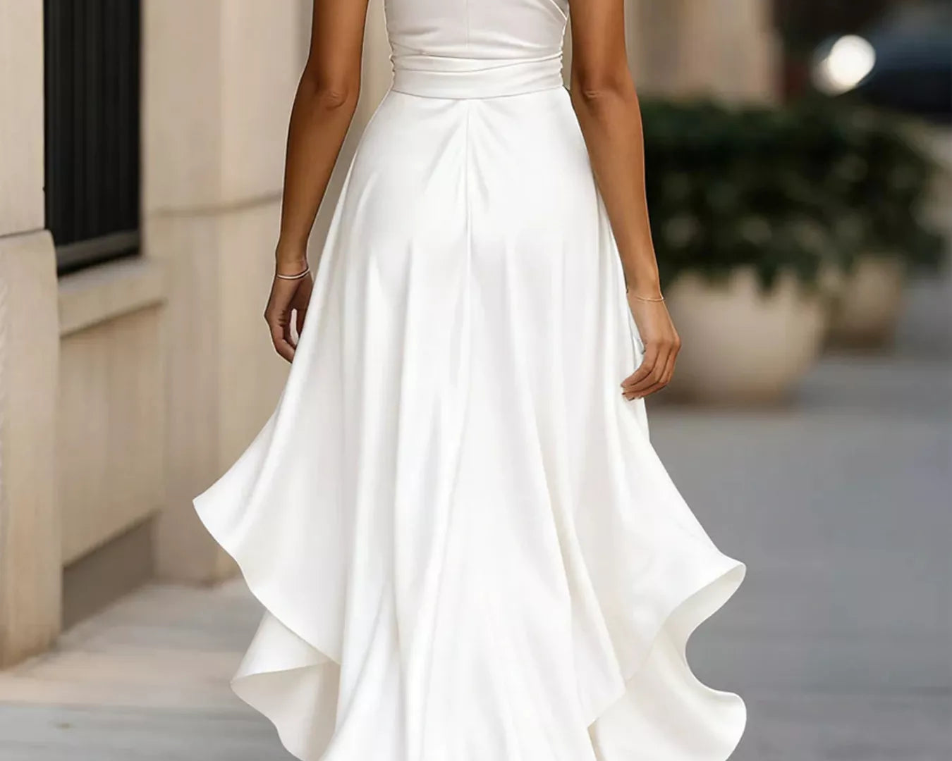 NEWYORKLISTED STYLE COLLECTION: Woman wearing a white halter neck dress walking on a sidewalk.