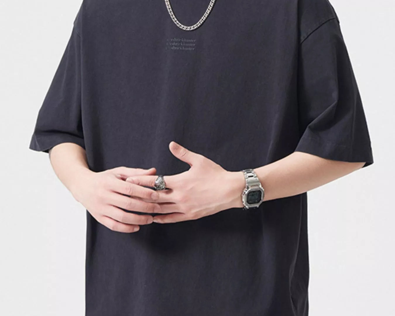 NEWYORKLISTED ATLAS MEN's COLLECTION: Person wearing a black oversized t-shirt with a plain background