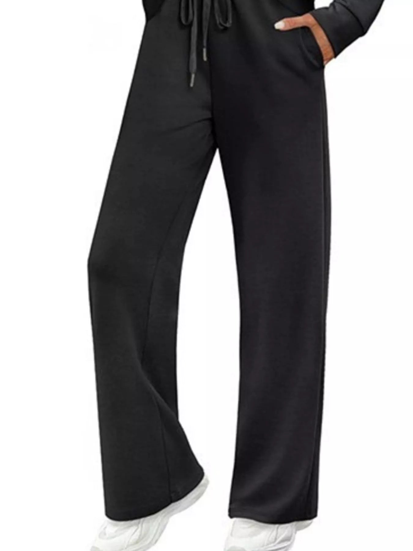 Black wide-leg pants worn with a black hoodie on a white background