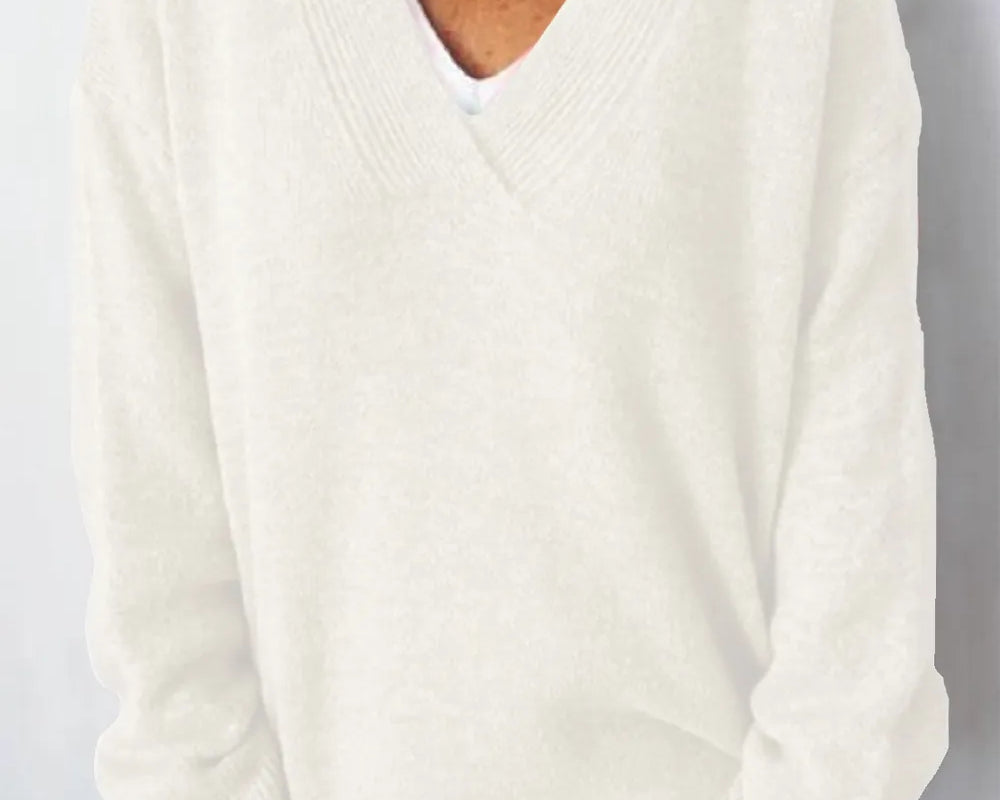 NEWYORKLISTED STYLE COLLECTION V-Neck Dropped Shoulder Sweater in soft knit white fabric on a minimalist white background