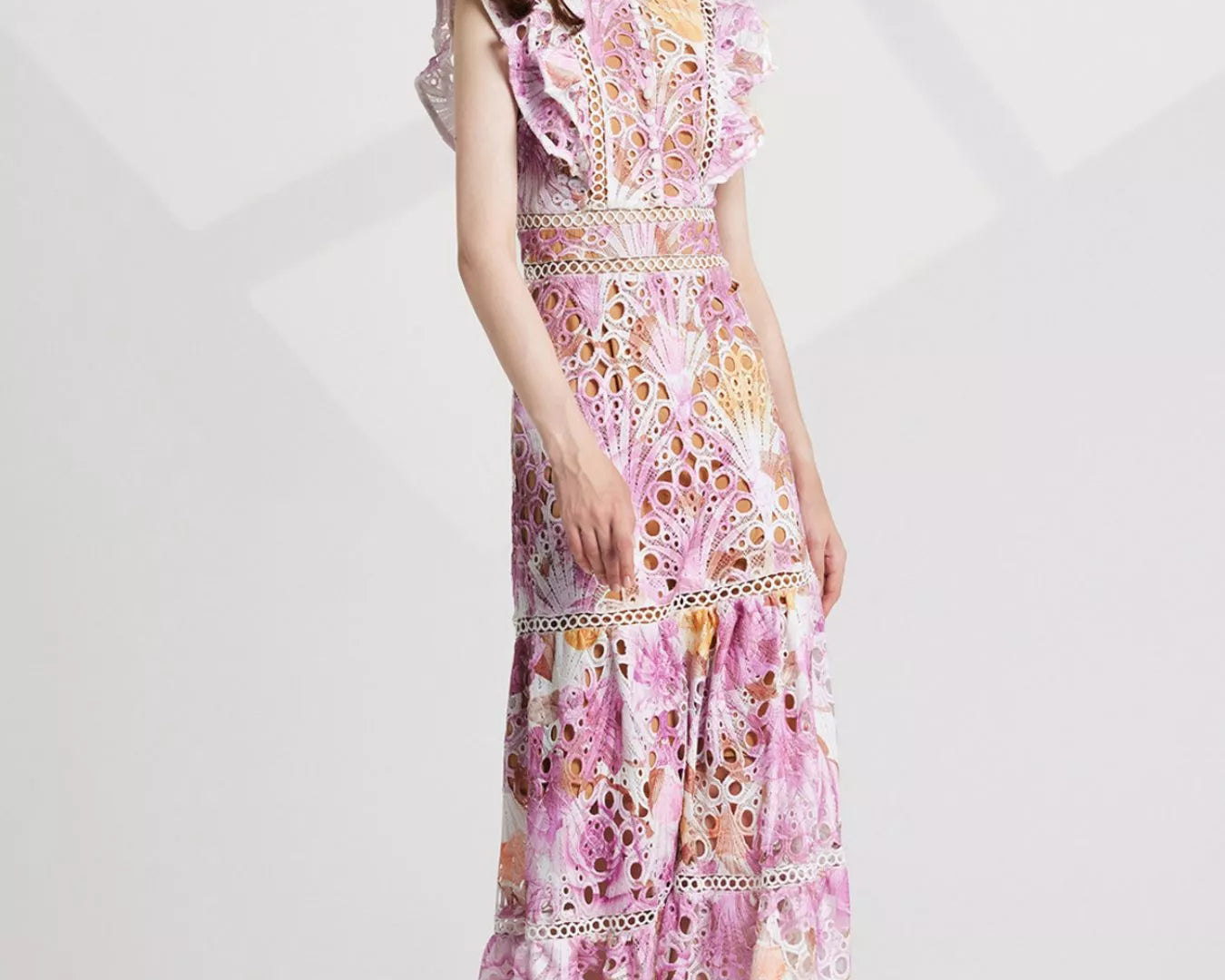 NEWYORKLISTED STYLE COLLECTION: Woman wearing a floral dress on a white background
