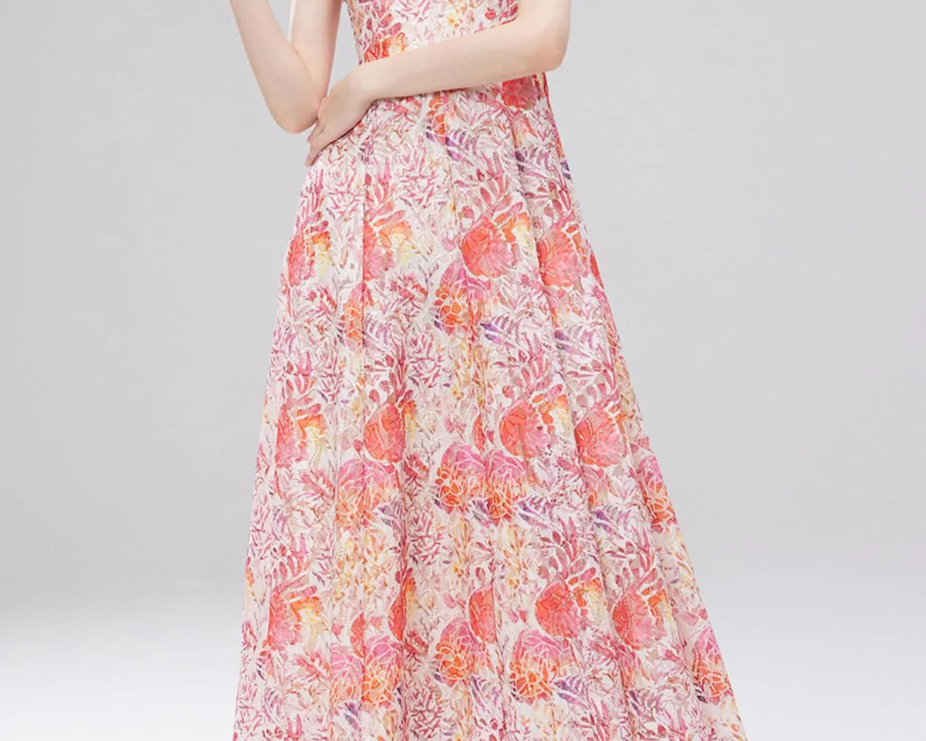 NEWYORKLISTED STYLE COLLECTION: Woman wearing a floral dress on a gray background