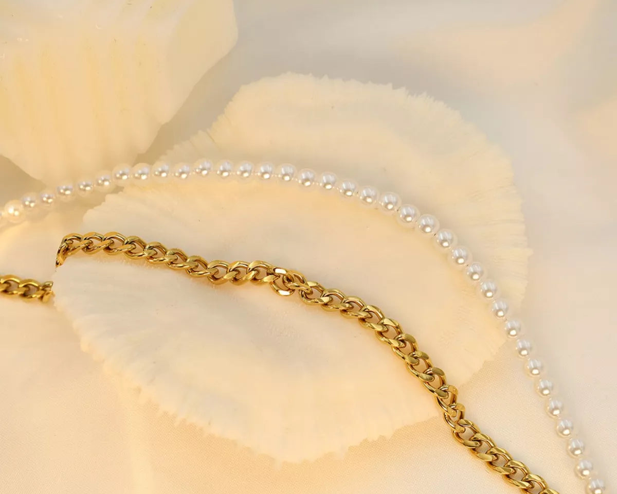 NYLD Glamour Collection by NEWYORKLISTED: Gold chain and pearl necklace on a soft beige background