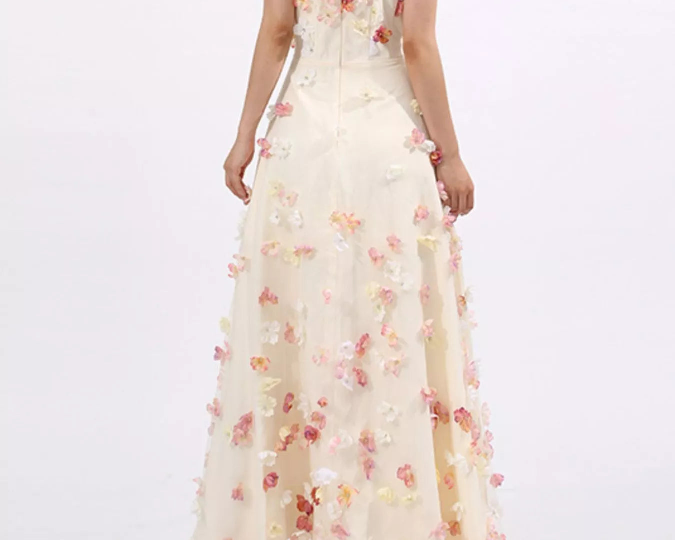 NEWYORKLISTED STYLE COLLECTION: Woman wearing a strapless floral gown on a white background