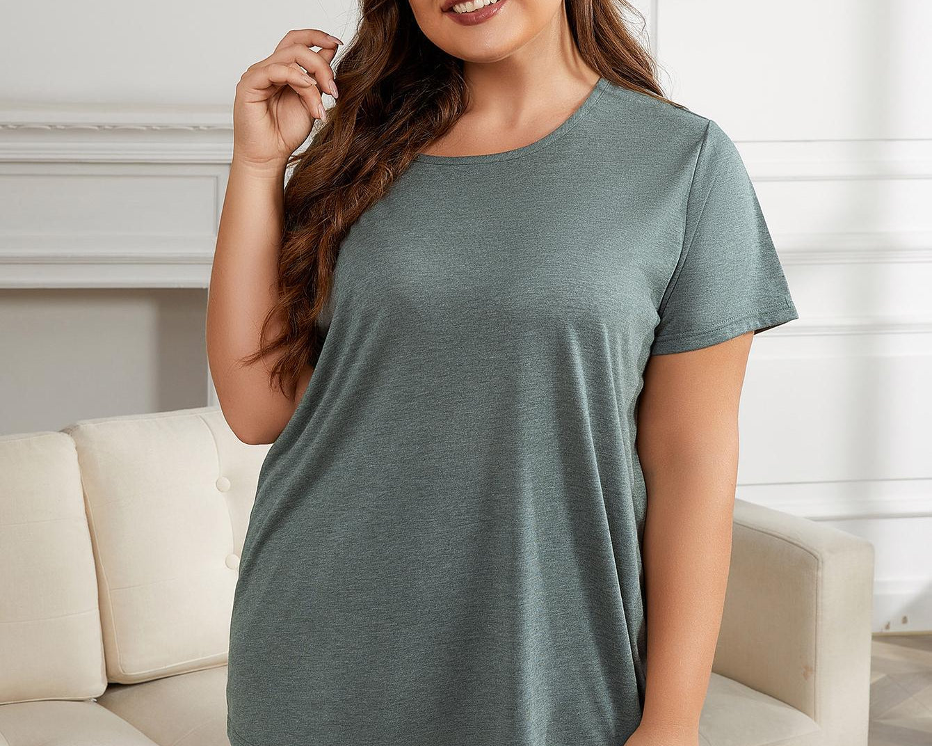 NEWYORKLISTED Intimate Apparel Collection: Woman wearing a green t-shirt and shorts set in a living room.