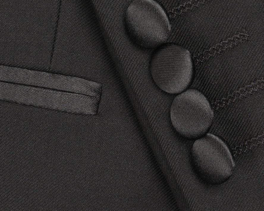 Close-up of a dark gray suit jacket with buttons and a lapel.