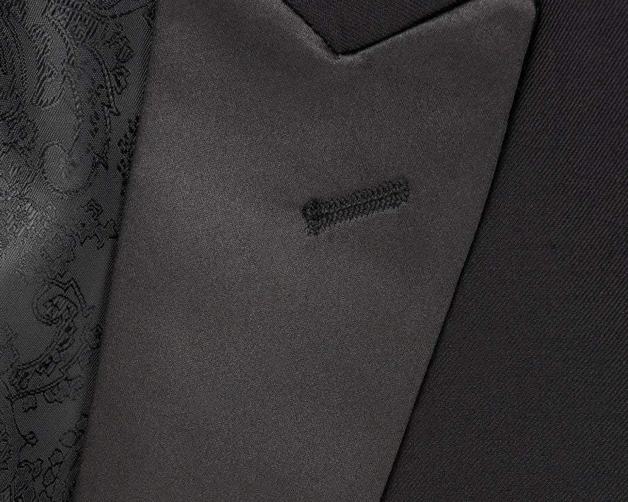 Close-up of a dark gray suit jacket with a pocket detail.