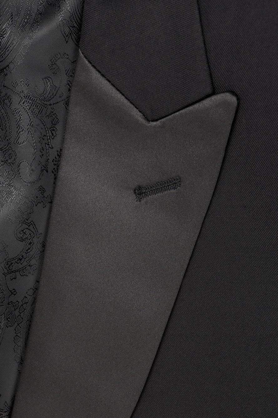 Close-up of a dark gray suit jacket with a pocket detail.