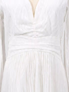 NEWYORKLISTED STYLE COLLECTION: Close-up of a white dress with a textured fabric and pleated design.
