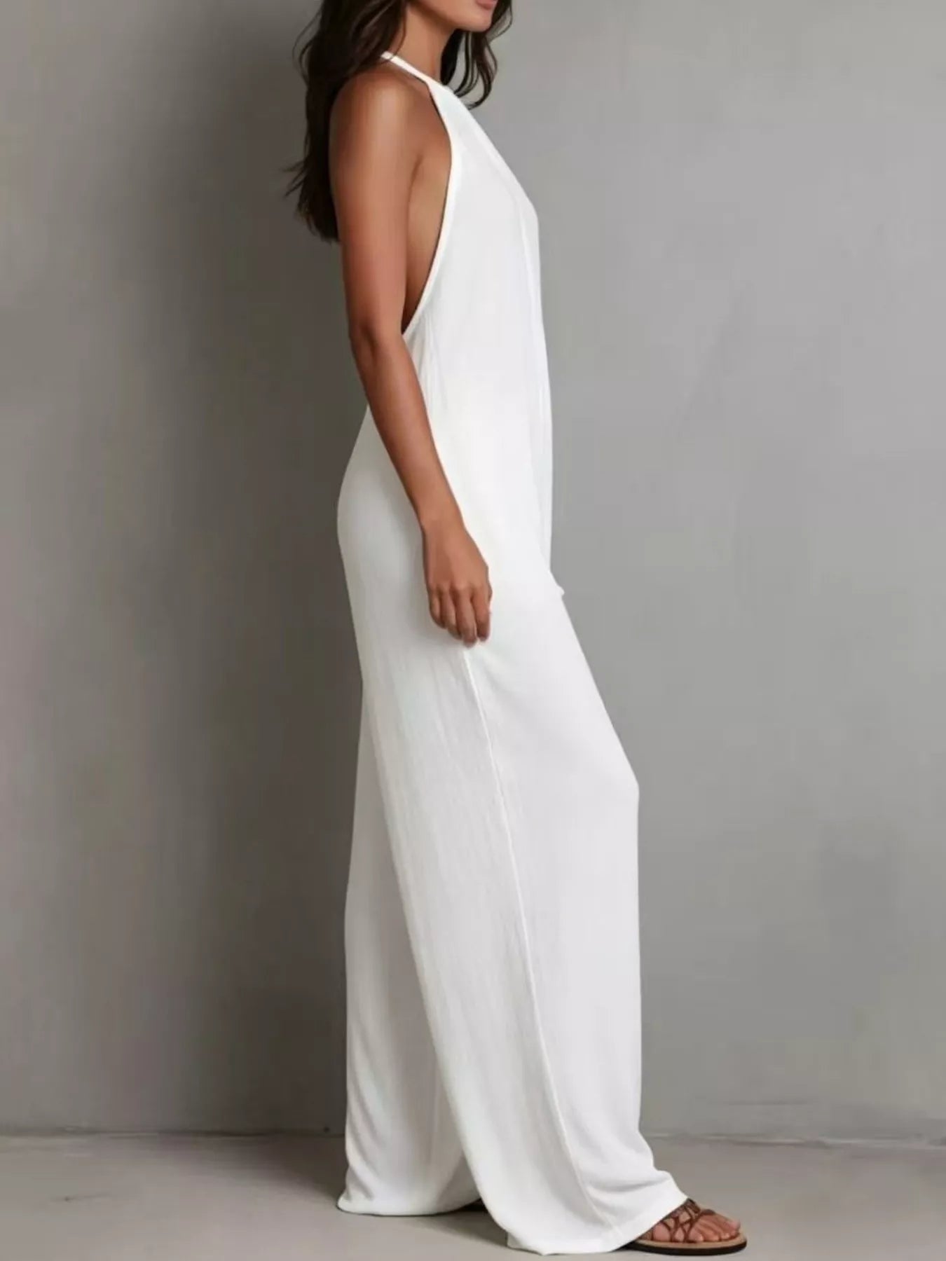 NEWYORKLISTED STYLE COLLECTION: Woman wearing a white sleeveless dress against a gray background