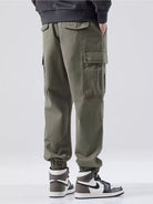 NEWYORKLISTED ATLAS MEN'S COLLECTION: Person wearing olive green cargo pants with a white background