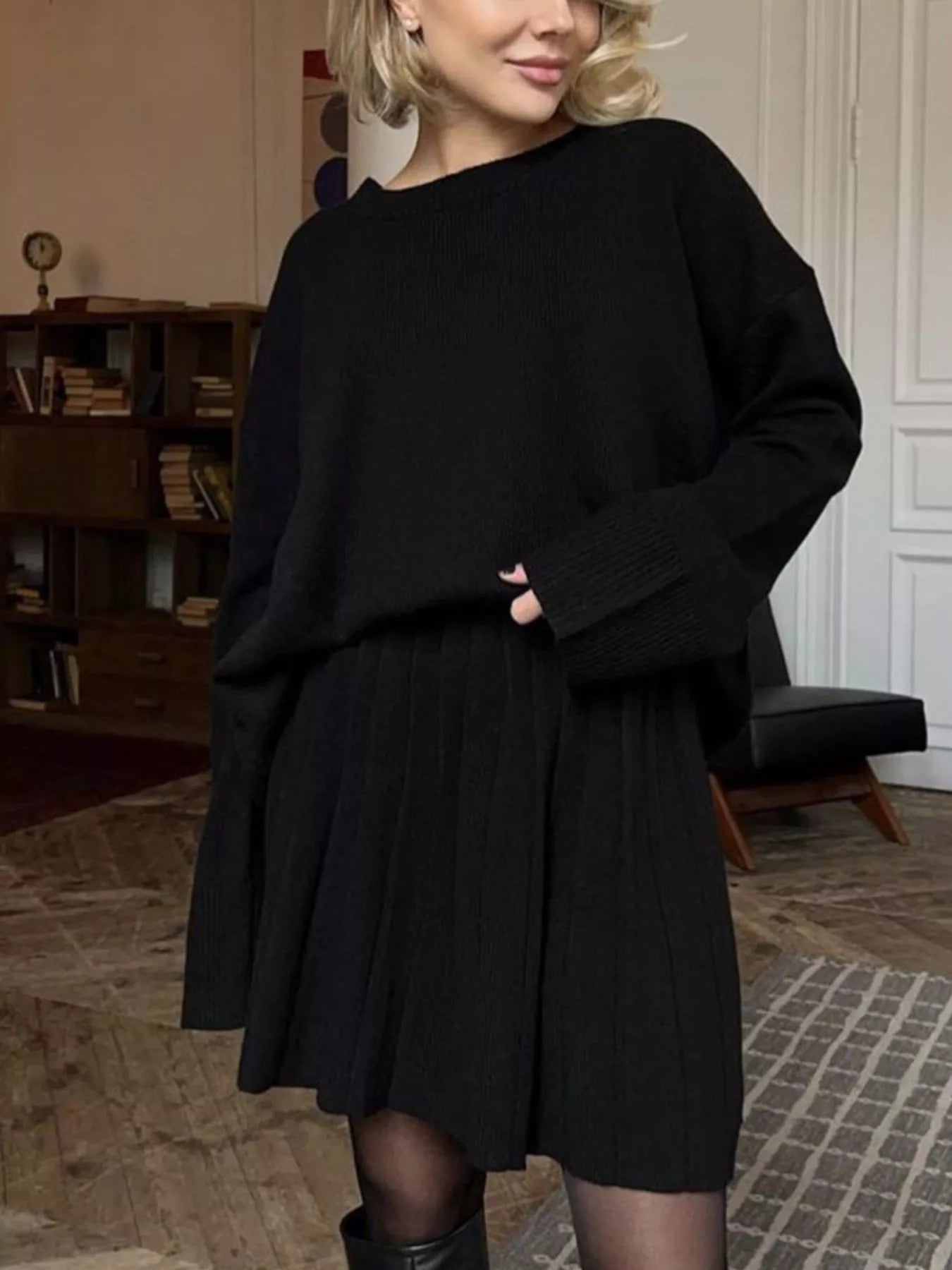 NEWYORKLISTED STYLE COLLECTION: Woman wearing a black outfit in an indoor setting
