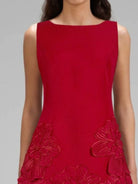 NEWYORKLISTED STYLE COLLECTION: Red dress with floral embellishments on a gray background