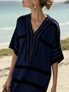 NEWYORKLISTED STYLE COLLECTION: Woman wearing a blue and black patterned dress on a beach.