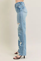 NEWYORKLISTED STYLE COLLECTION: Light blue distressed jeans worn by a person on a plain background