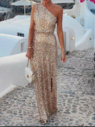NEWYORKLISTED STYLE COLLECTION: Sequin One-Shoulder Slit Maxi Dress, models wearing a one-shoulder dress standing on a stone path with white buildings and umbrellas in the background.