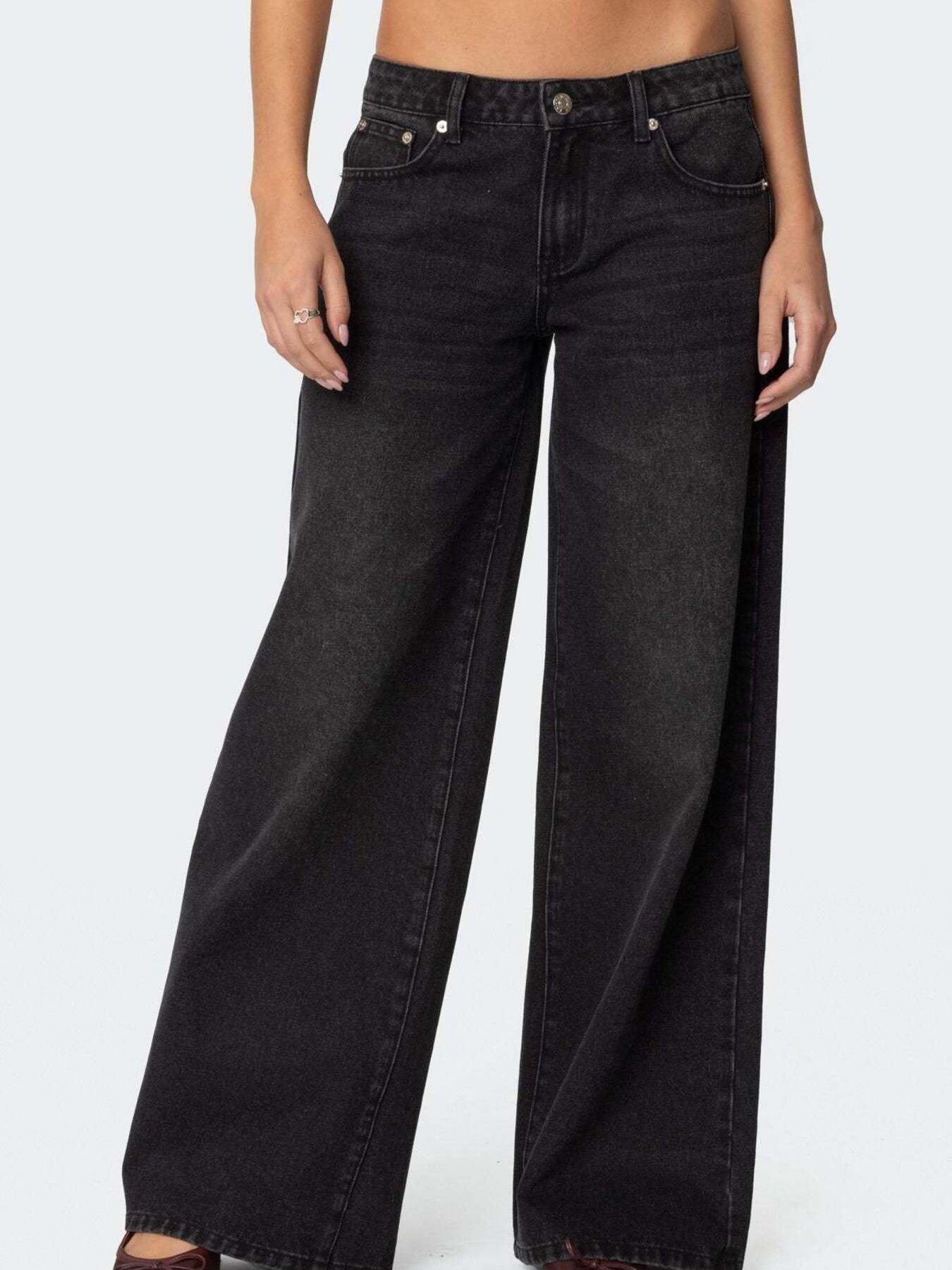 NEWYORKLISTED STYLE COLLECTION: Black wide-leg jeans worn by a person on a white background