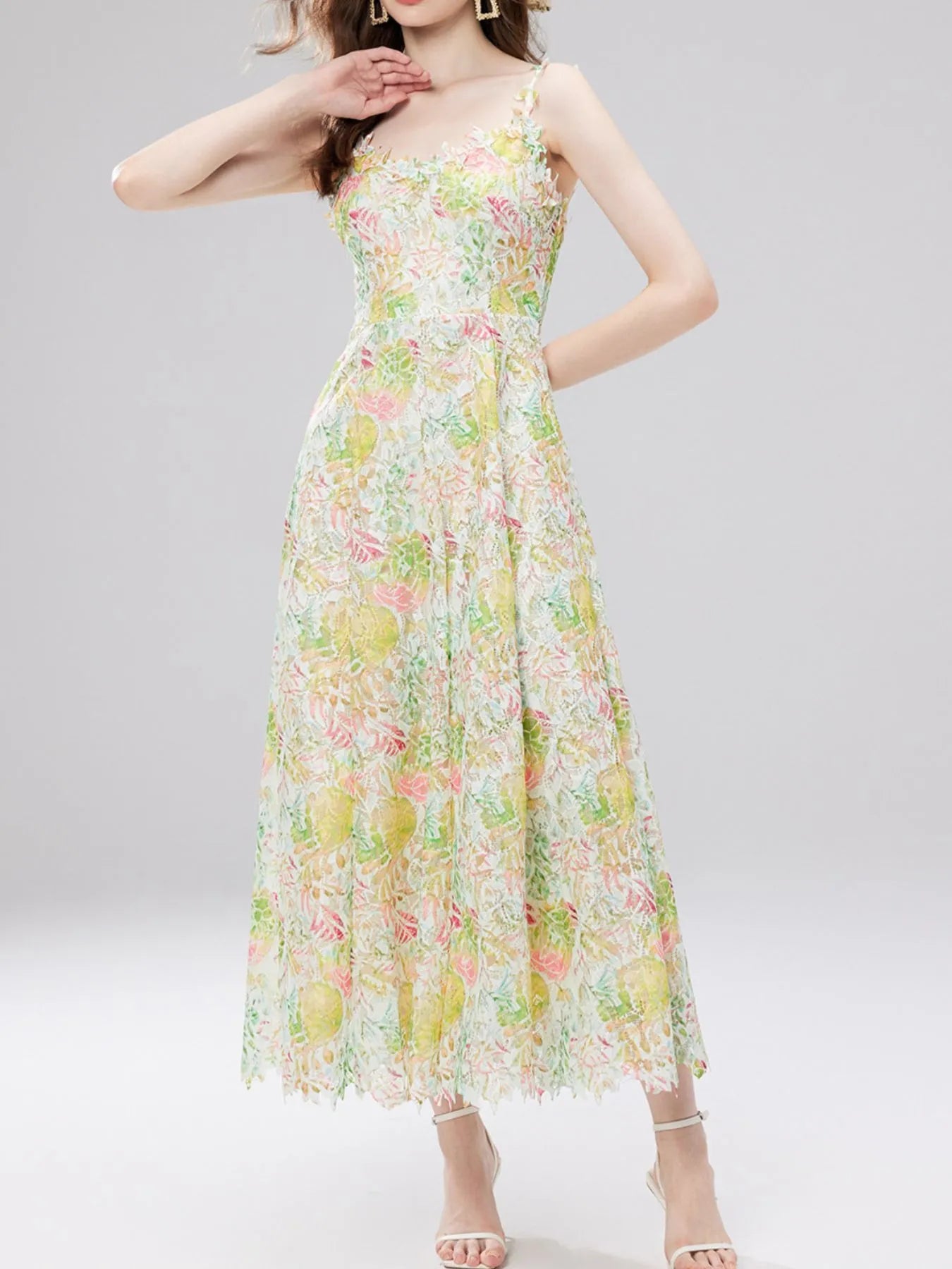 NEWYORKLISTED STYLE COLLECTION: Woman wearing a floral dress on a gray background