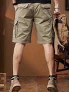 NEWYORKLISTED ATLAS MEN's COLLECTION: Person wearing beige cargo shorts with a brown backpack indoors.