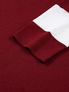 Close-up of a burgundy fabric with a white trim pocket
