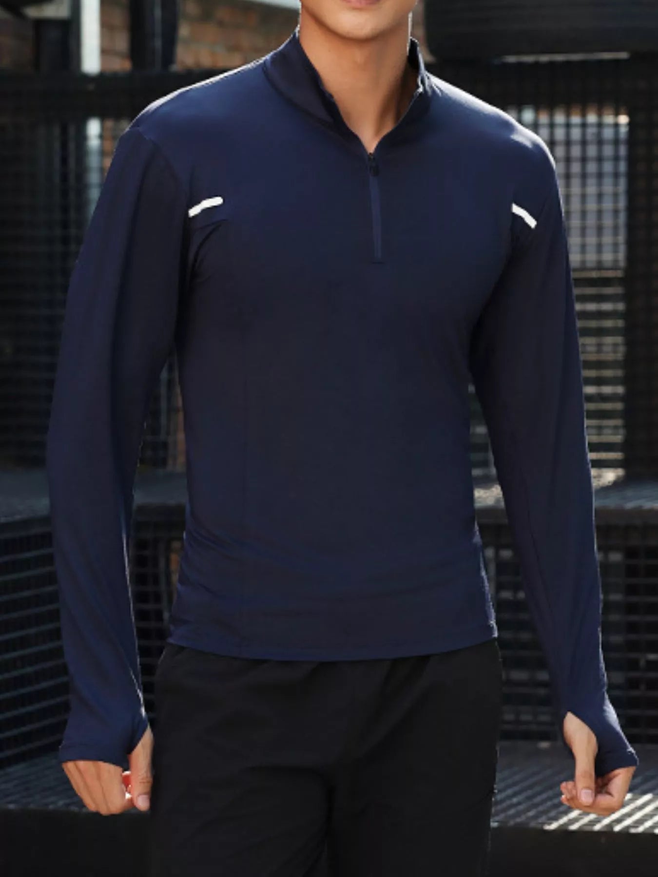 NEWYORKLISTED ATLAS MEN'S COLLECTION: Person wearing a navy long-sleeve athletic shirt with white accents against a dark background