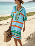 NEWYORKLISTED STYLE COLLECTION: Woman wearing a colorful striped dress on a beach