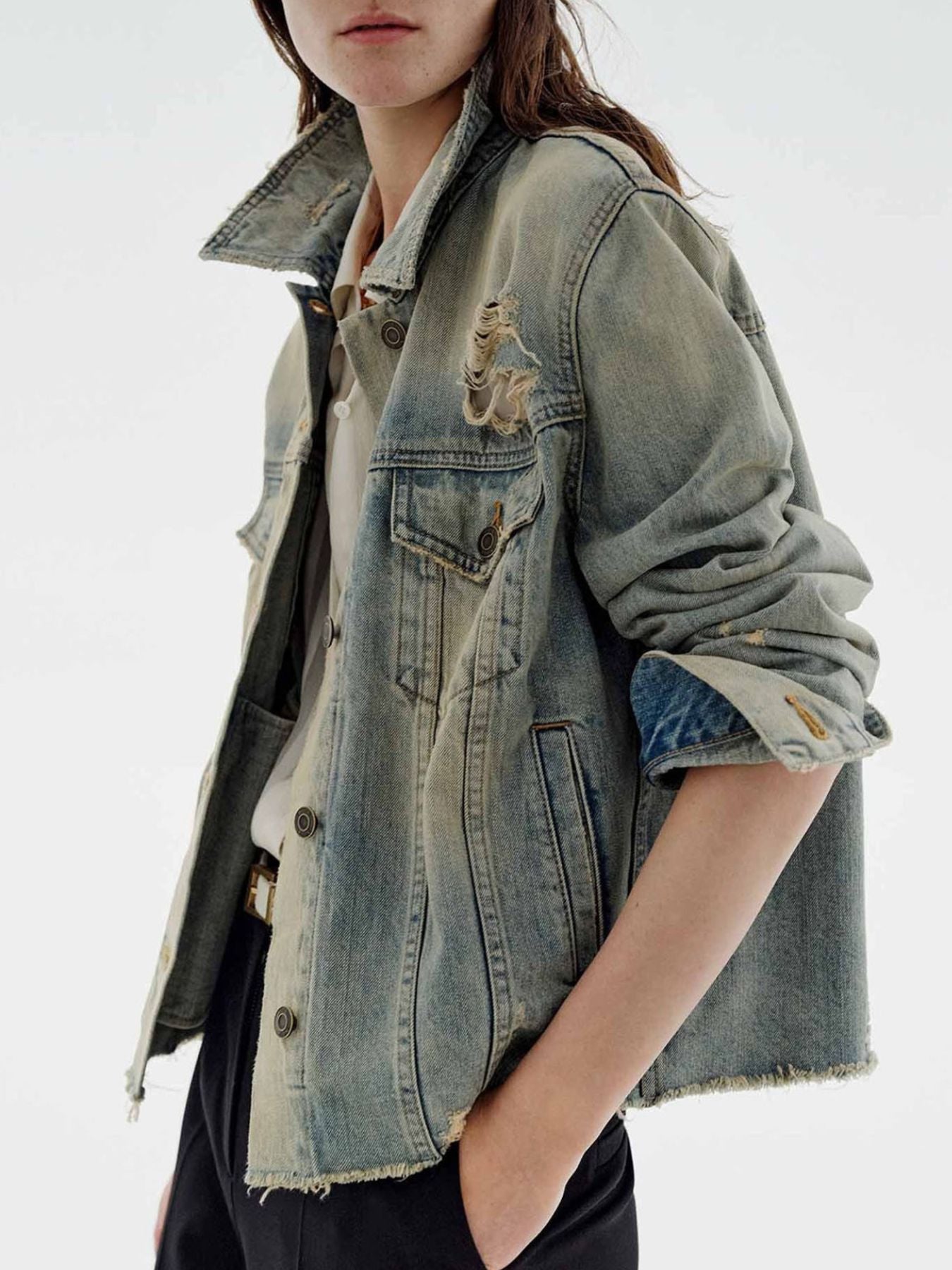 NEWYORKLISTED STYLE COLLECTION: Person wearing a denim jacket with embroidered designs on a white background