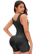 NEWYORKLISTED Intimate Apparel: Woman wearing a black shapewear bodysuit on a white background