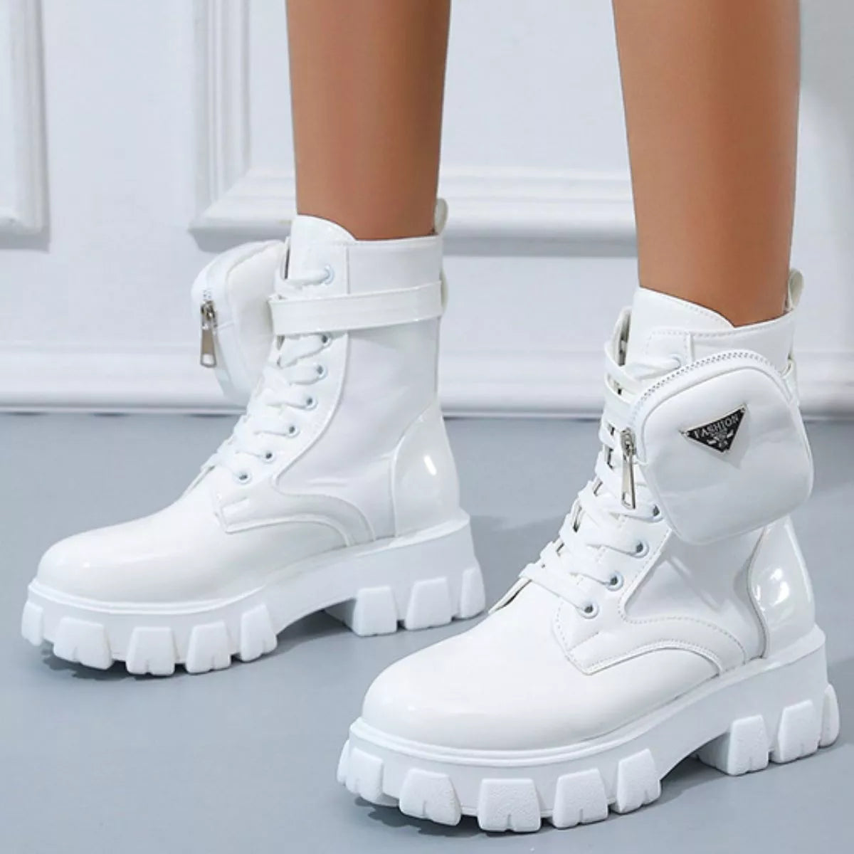 NEWYORKLISTED SHOE COLLECTION: White platform boots with zippers on a light gray background