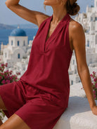 NEWYORKLISTED STYLE COLLECTION: Woman in a red dress with a scenic background of a blue-domed church.