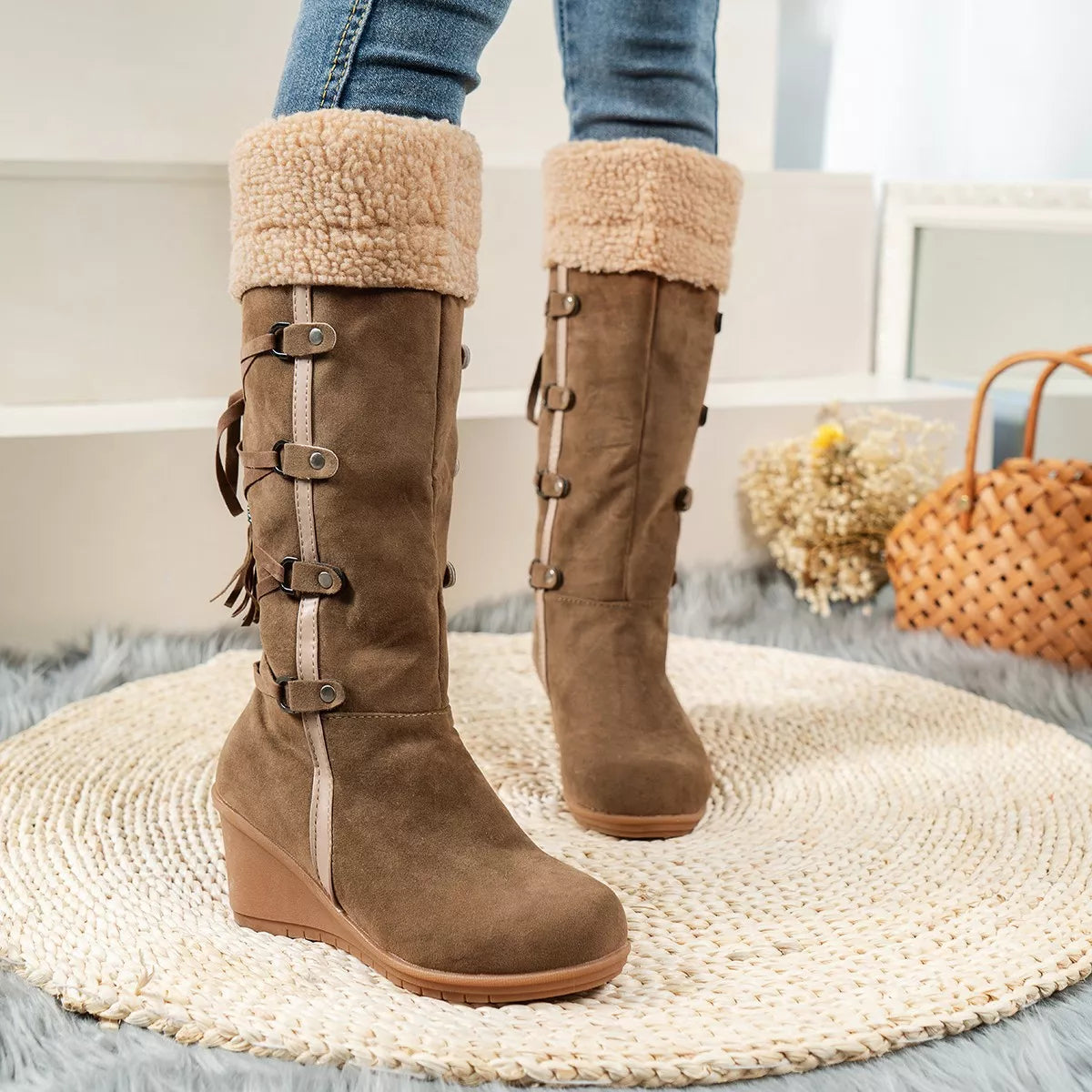 NEWYORKLISTED SHOE COLLECTION: Brown knee-high boots with fur trim worn by a person on a textured rug.