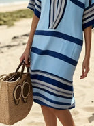 NEWYORKLISTED STYLE COLLECTION: Person wearing a blue and white striped dress on a beach