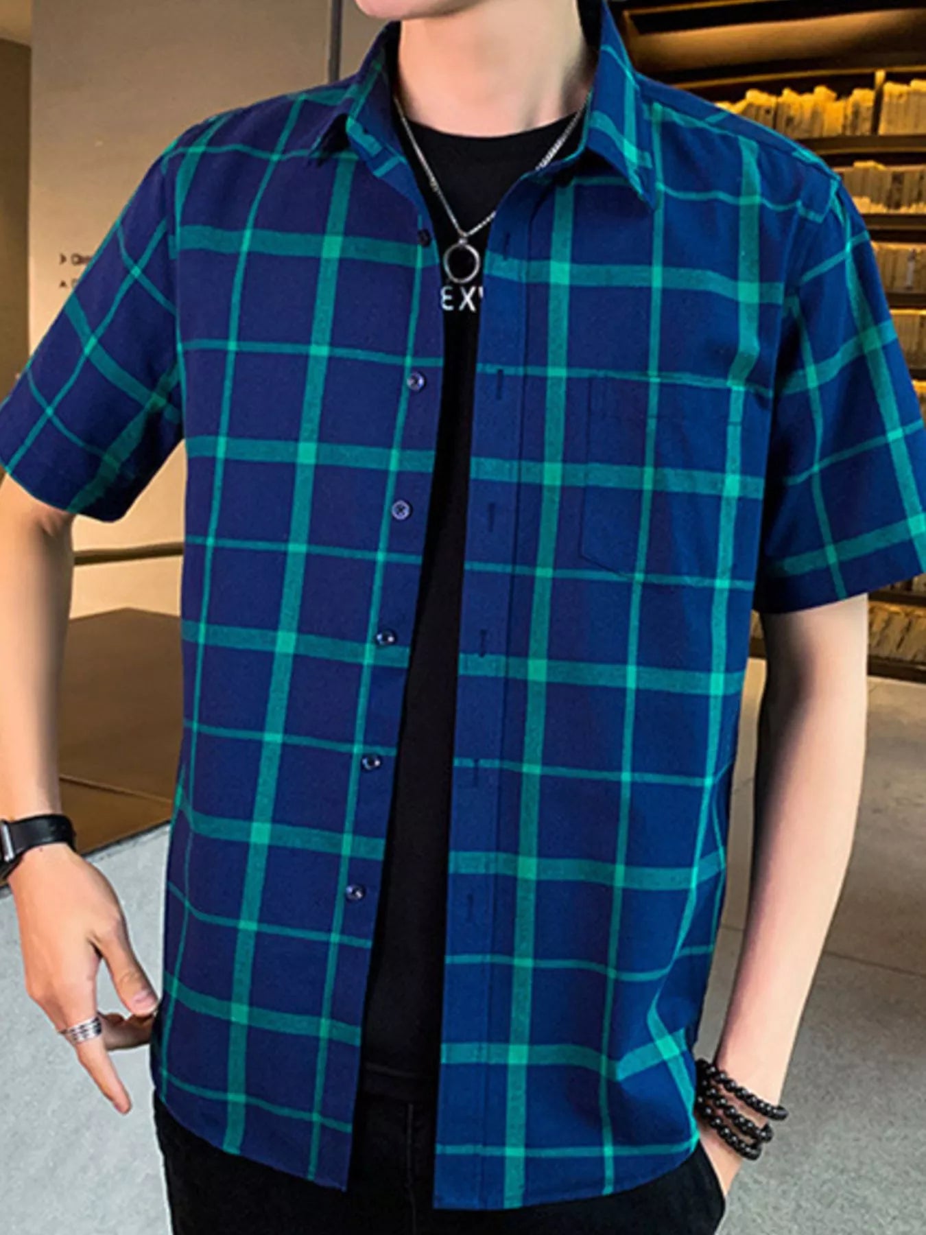 NEWYORKLISTED ATLAS MEN'S COLLECTION: Person wearing a blue and green checkered shirt indoors.