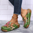 NEWYORKLISTED SHOE COLLECTION: Green floral sandals worn with denim jeans on a light background
