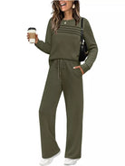 NEWYORKLISTED COMFORT COLLECTION: Woman wearing a green tracksuit holding a coffee cup on a white background