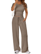 NEWYORKLISTED COMFORT COLLECTION: Woman wearing a beige crop top and wide-leg pants on a white background