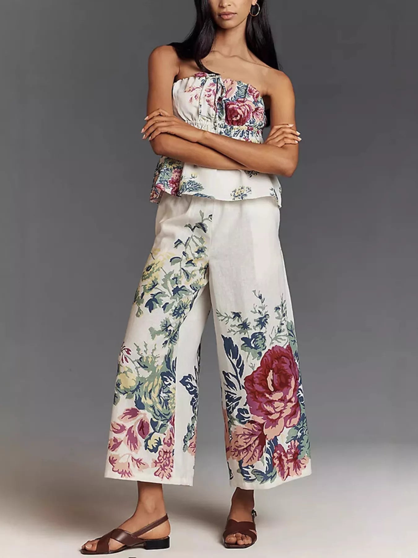 NEWORKLISTED STYLE COLLECTION: Woman wearing a floral top and wide-leg pants against a gray background