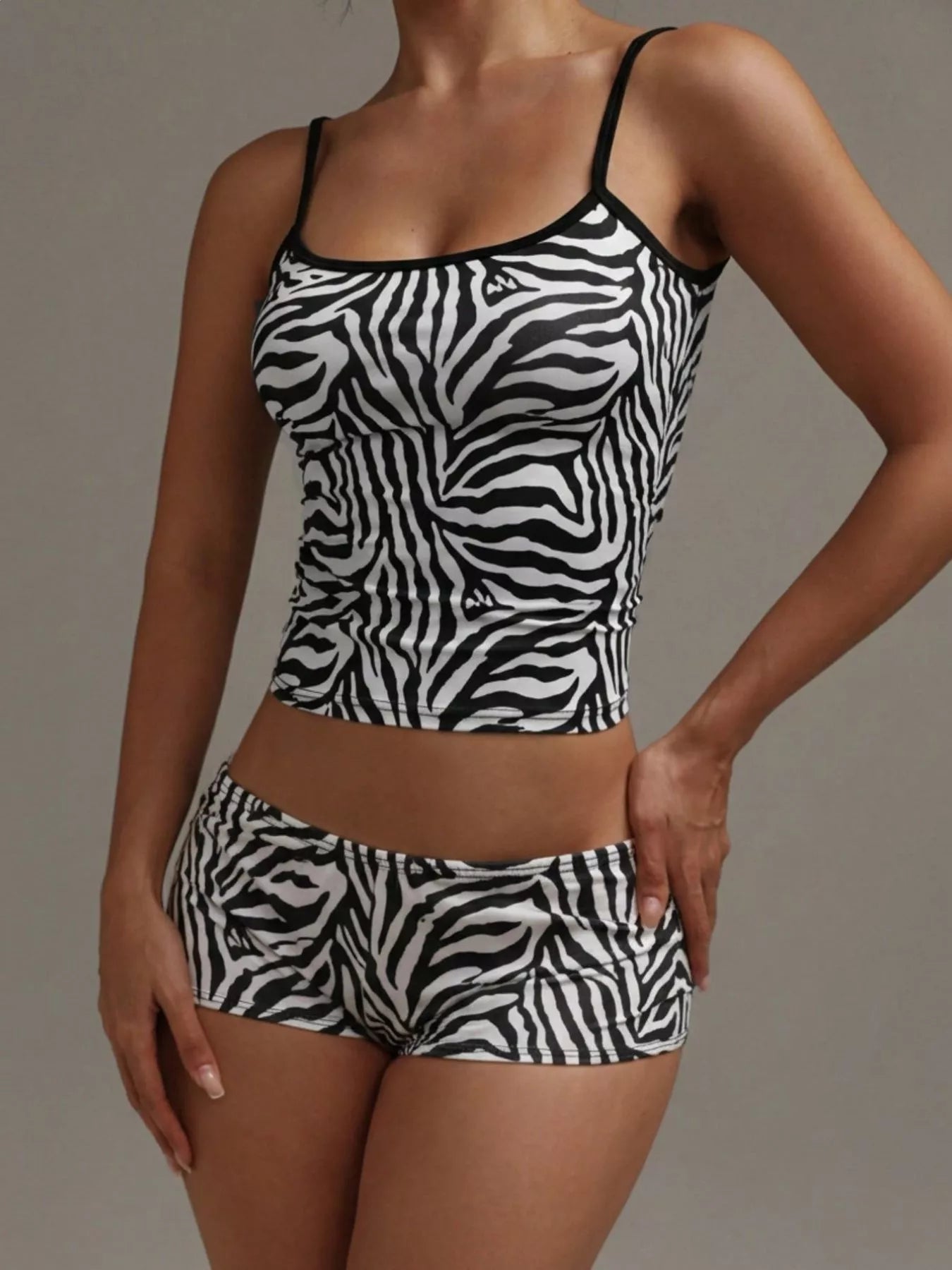 NEWYORKLISTED INTIMATE APPAREL COLLECTION: Person wearing a zebra print tank top and shorts set against a neutral background