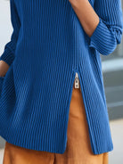 NEWYORKLISTED STYLE COLLECTION: Blue ribbed sweater with a zipper detail worn by a person, blurred background