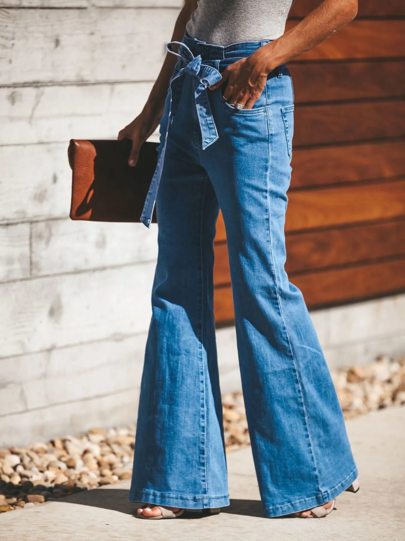 High-Waisted Tie-Front Flare Jeans from the NEWYORKLISTED STYLE COLLECTION. Waist-slimming bow detail, premium stretch denim, and elongated flare silhouette. Shop luxury-inspired fashion at NEWYORKLISTED.COM